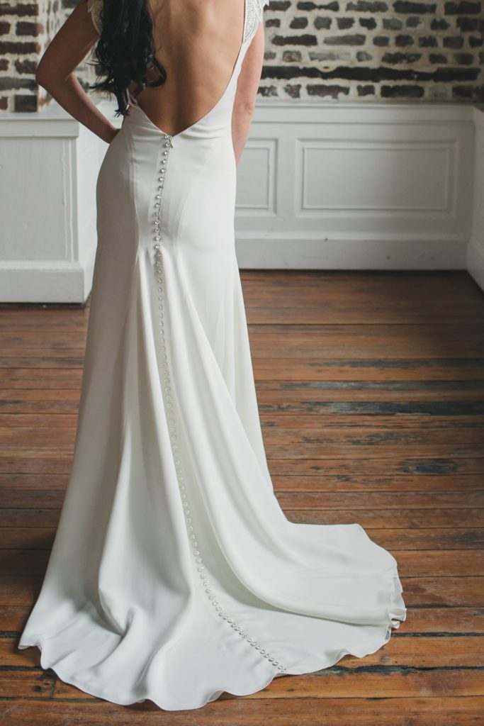 Crystal button detail down the back of the Tamarisk crepe wedding gown