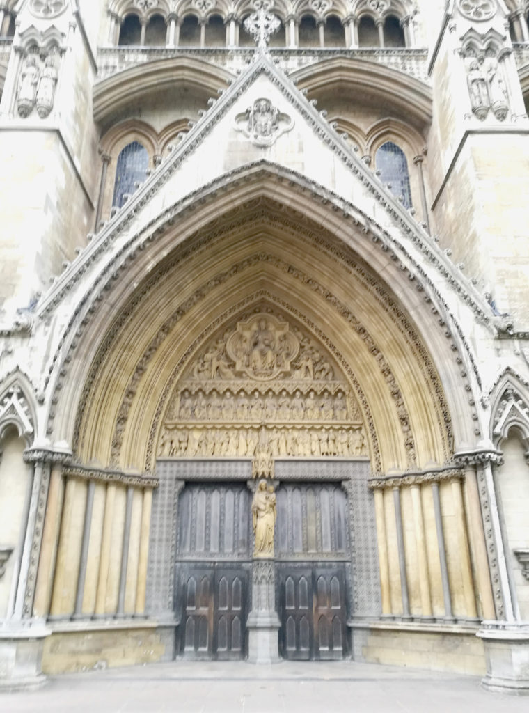 Eye level view of the doors and arched doorway of Westminster Abbey