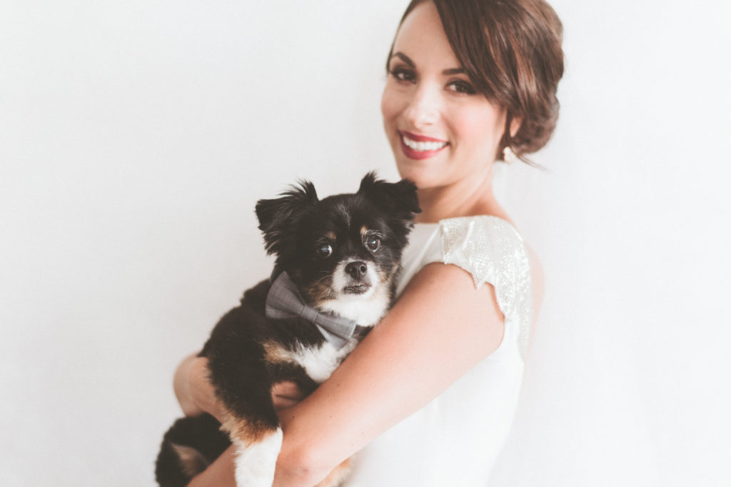 Bridal portrait of a bride with her dog in a bowtie
