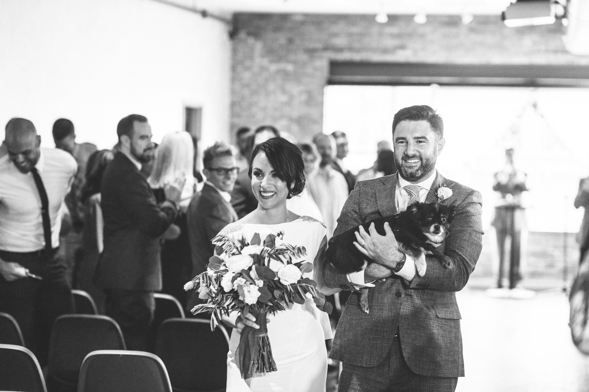 Real Chicago bride and groom exit the wedding ceremony with their dog