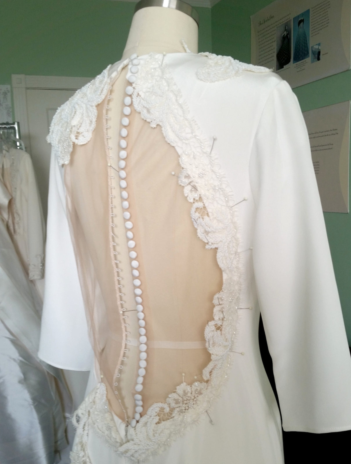 Placing the beaded lace trim around the illusion back keyhole on the Leyla wedding dress style