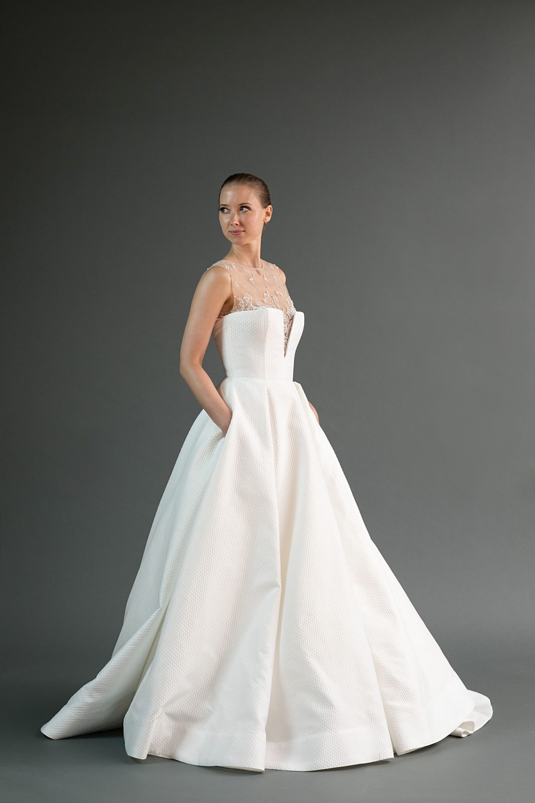 Kei is a textured wedding dress with pockets and an illusion neckline