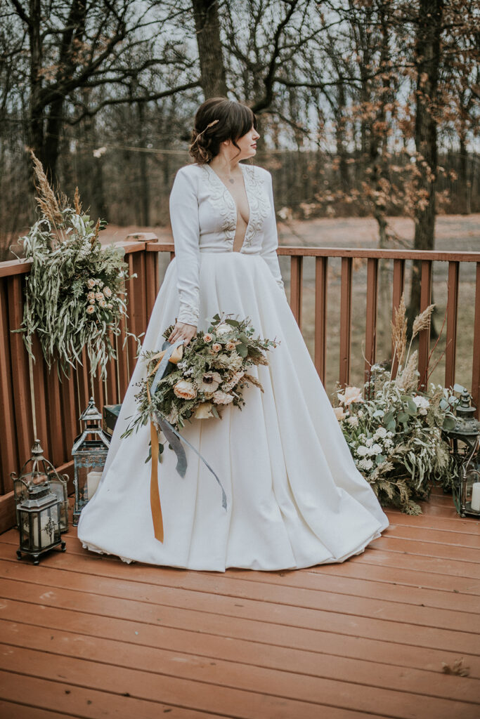The Iman ballgown wedding dress with sleeves styled for a fall camp wedding.