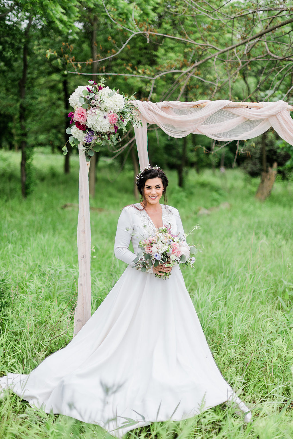 The Iman ballgown wedding dress with sleeves styled for an outdoor nature spring wedding.