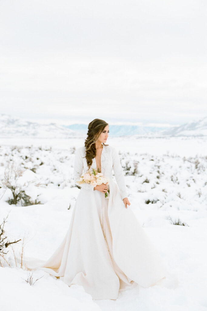 The Iman ballgown wedding dress with sleeves styled for a snowy winter wedding.