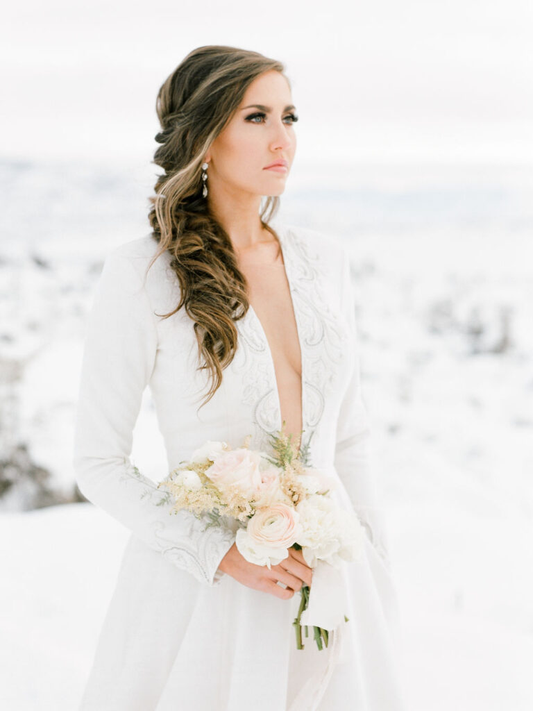 Dewy bridal makeup paired with the Iman ballgown wedding dress for a snowy winter wedding.