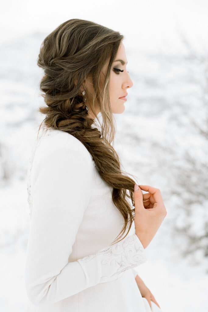Romantic braid hair style paired with Iman for a snowy winter wedding.