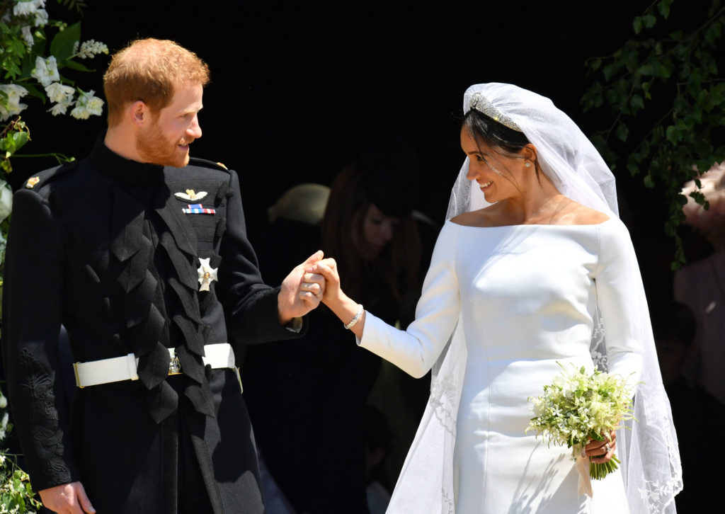 Prince Harry and Meghan Markle exit the church after the royal wedding holding hands