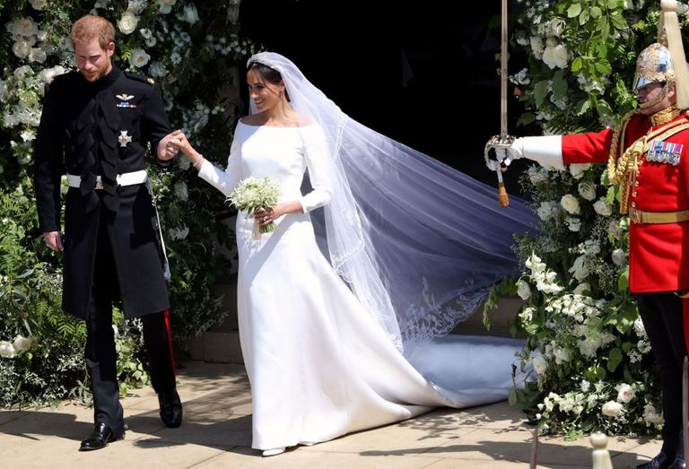 Meghan Markle exits the church after the royal wedding wearing a custom Givenchy wedding dress and veil
