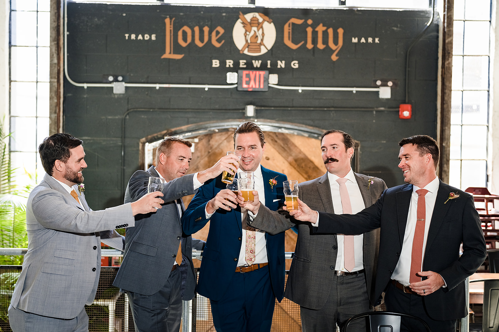 Groom getting ready with his groomsmen at Love City Brewing brewery in Philadelphia PA