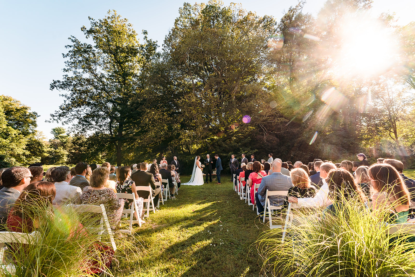 Outdoor wedding ceremony on the front lawn of the Awbury Arboretum in Philadelphia PA