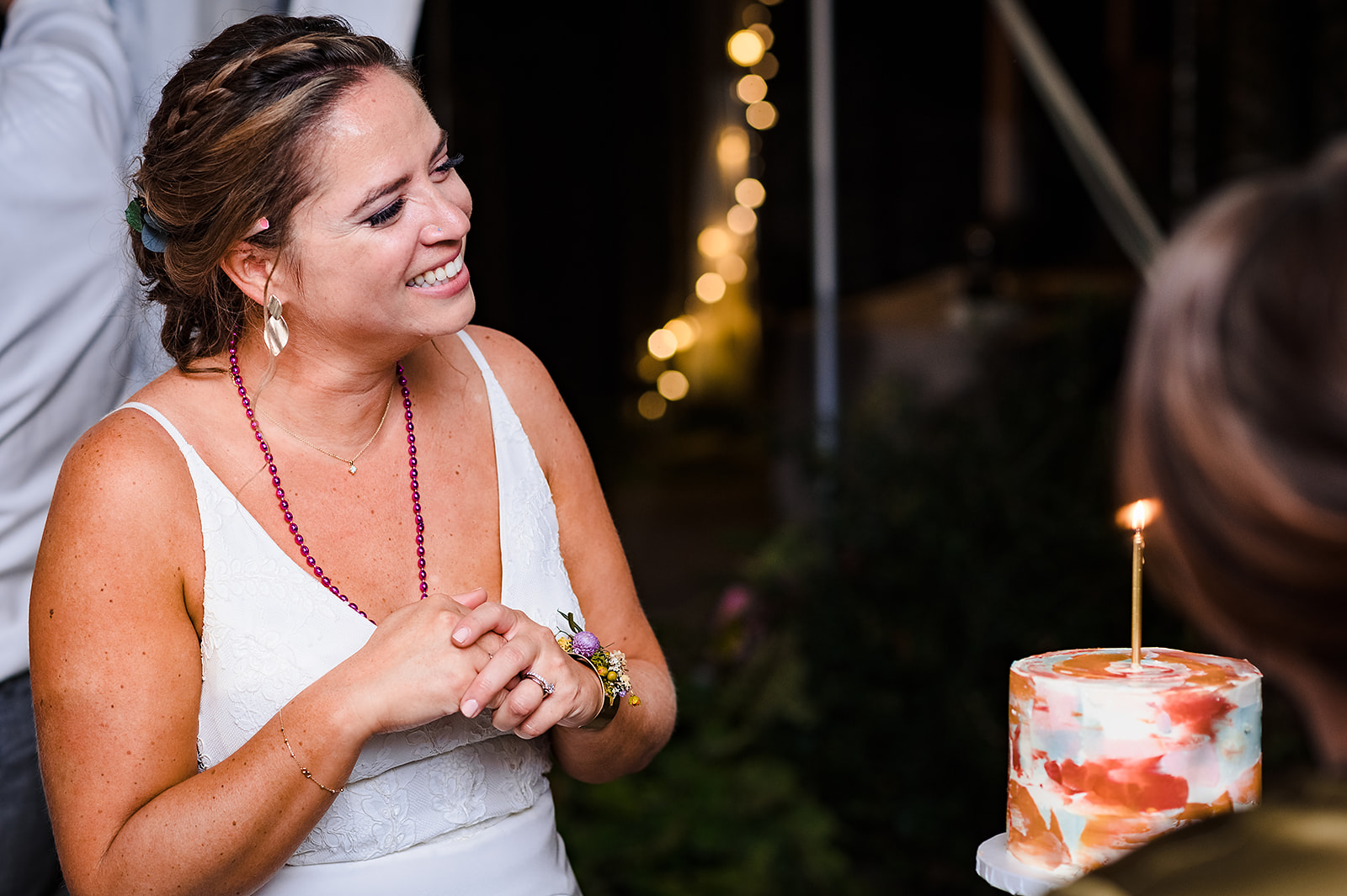Bride with birthday cake being sung happy birthday