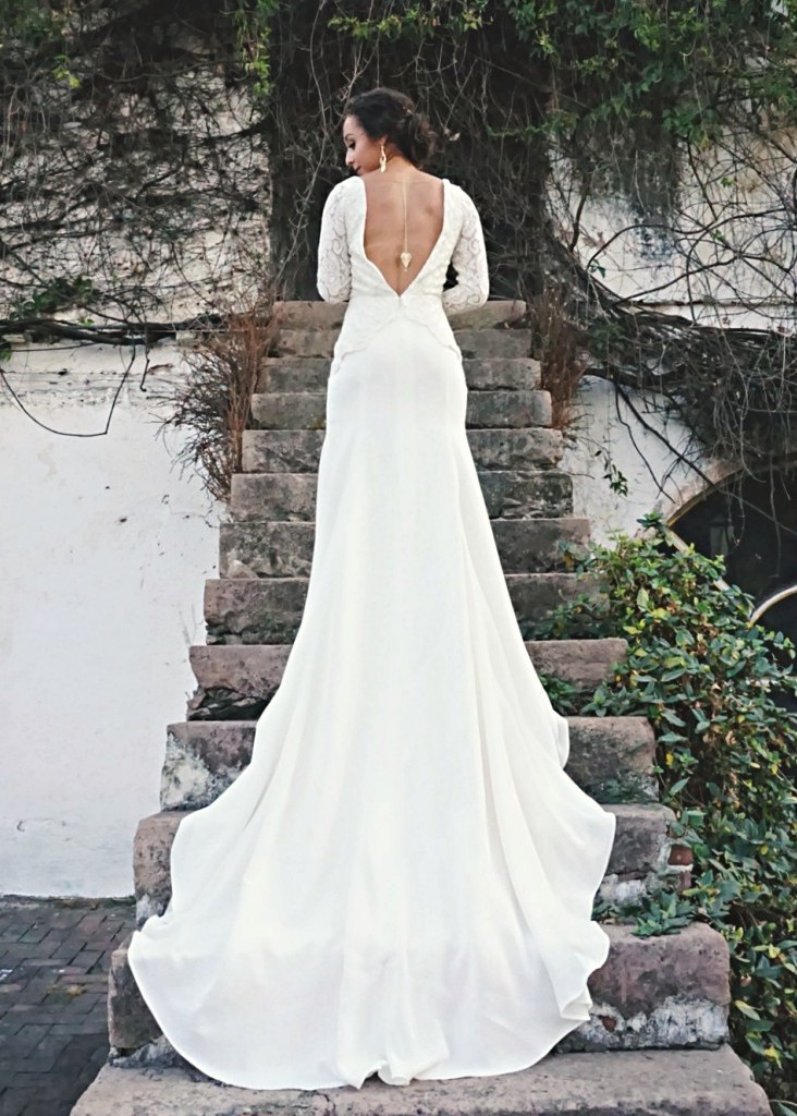 Bibi is a lace and crepe wedding dress with a v front and v back neckline and long sleeves.