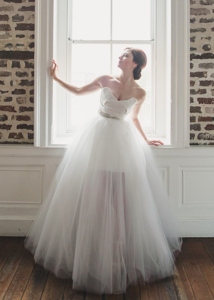 Dahlia is a two piece wedding dress set. A detachable tulle ballgown overskirt can be worn over the strapless mikado mini dress.