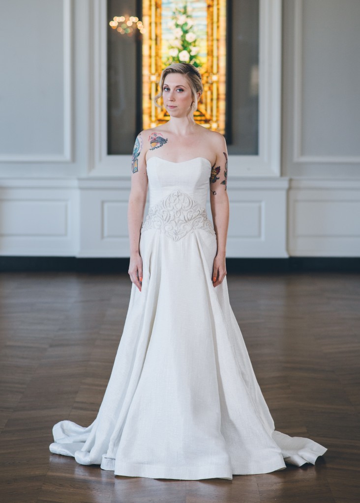 Izme is a strapless wedding dress in a textured silver jacquard with a custom embroidered waistline.