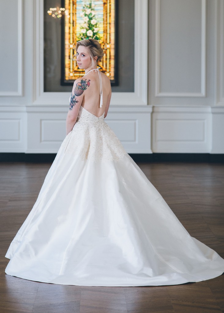 Karli by Edith Elan is a halter ballgown wedding dress with pockets. A two tone effect is created between the lace and mikado fabrics.