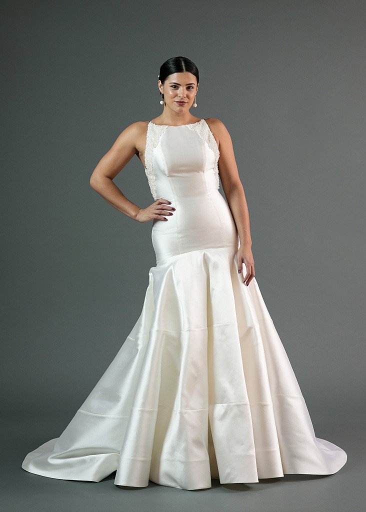 Rin by Edith Elan is a dropped waist fit and flare wedding dress in mikado. The high neck bodice is embellished with a pearl beading.