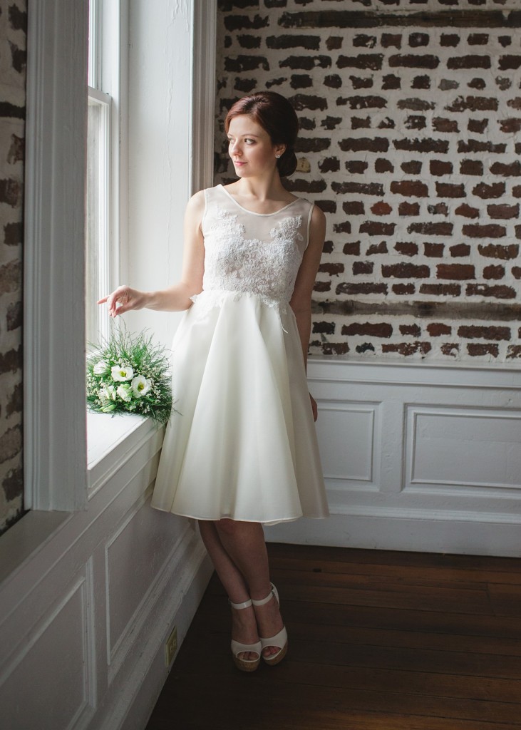Sage is a short A line wedding dress in silk gazar organza that gives a sheerness to the lace applique bodice.