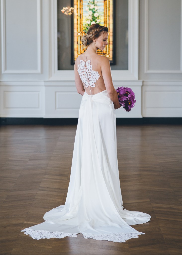 Tahani is a charmeuse wedding dress with lace appliques on the illusion back bodice and on the hem of the ties.
