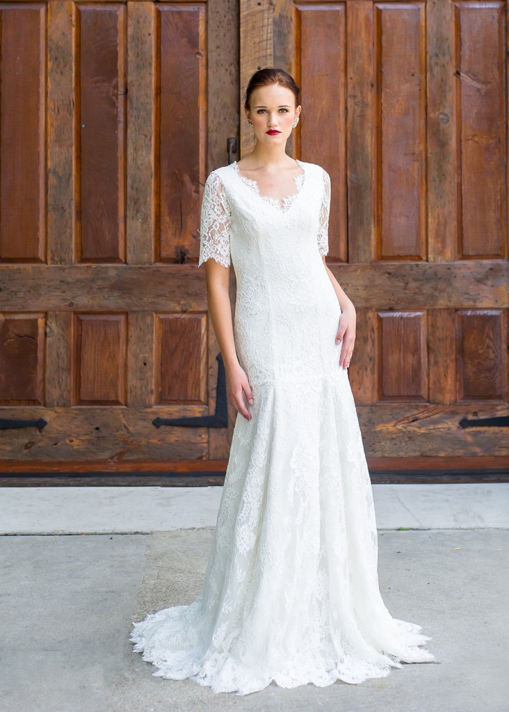 Olivia by Edith Elan is a lace and silk crepe wedding dress. The longer sleeves and modest V neck contrast with the low V back.