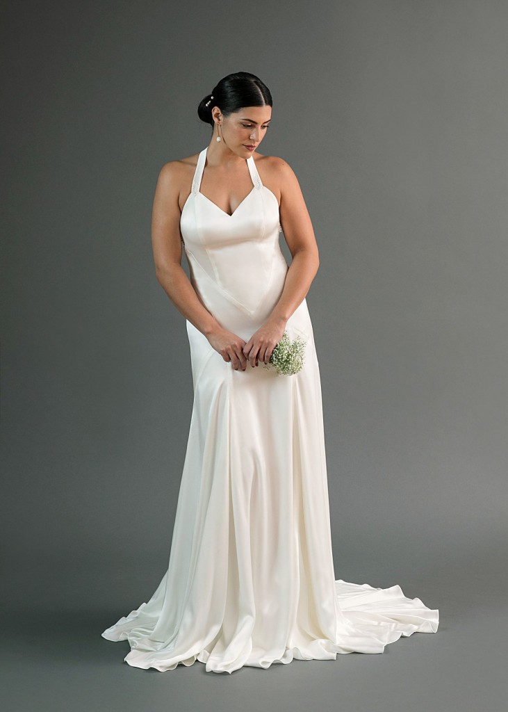 Yuri is a charmeuse wedding dress with intricate seams and an open X back.