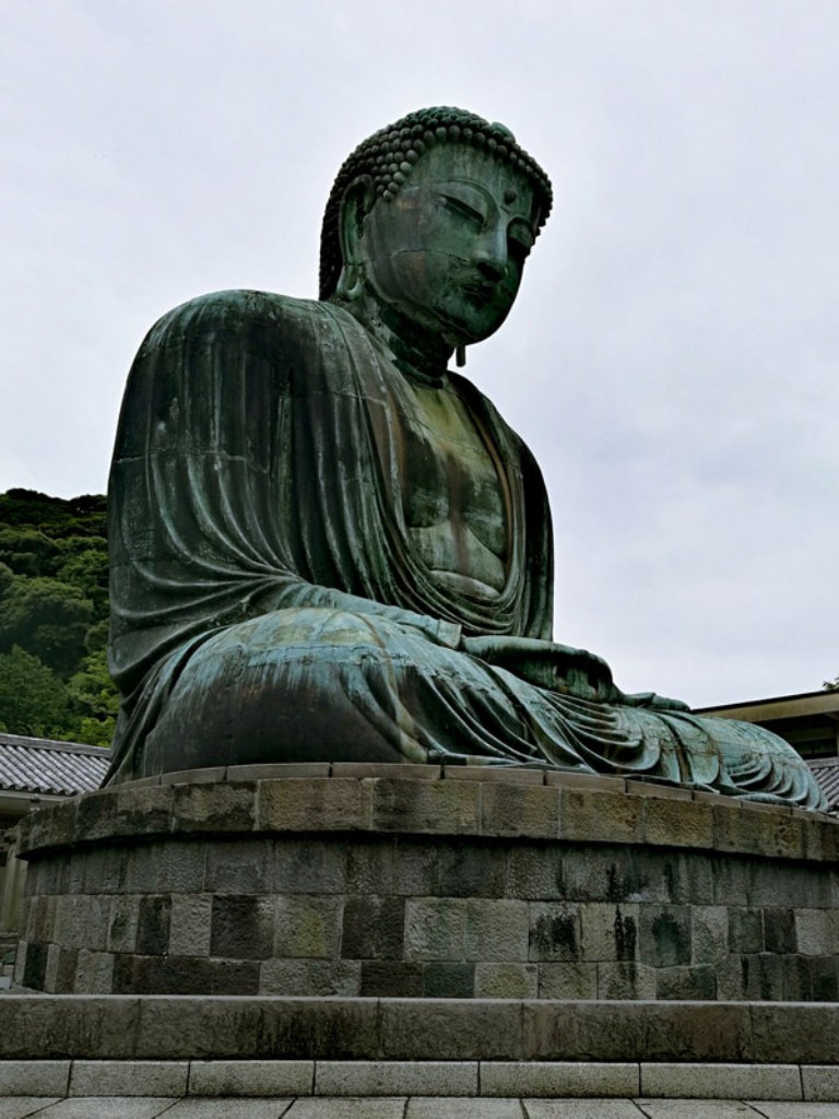 Three quarter view of the Great Buddha statue in Kamakura.