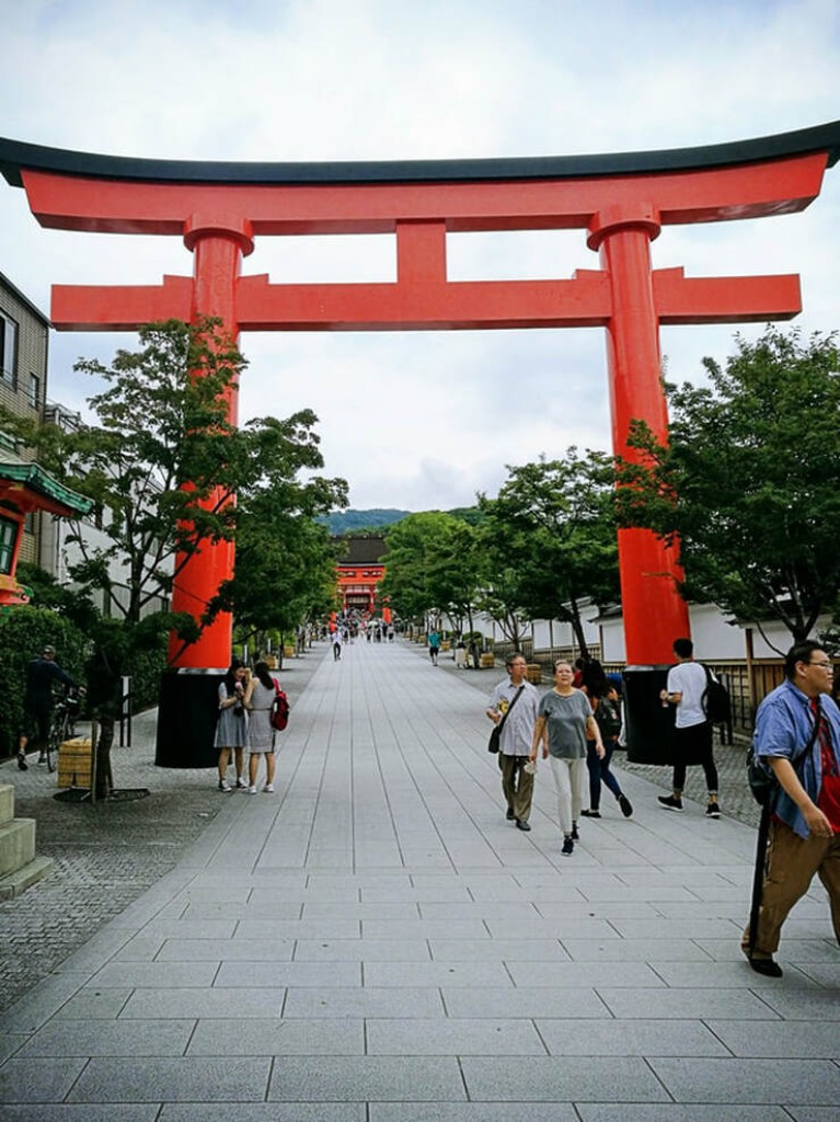 The large main orange gate of the Fushimi Inari shrine in Kyoto Japan.