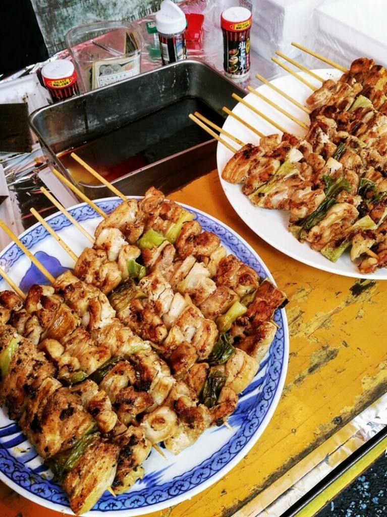 Plates filled with grilled skewers of veggies and chicken.