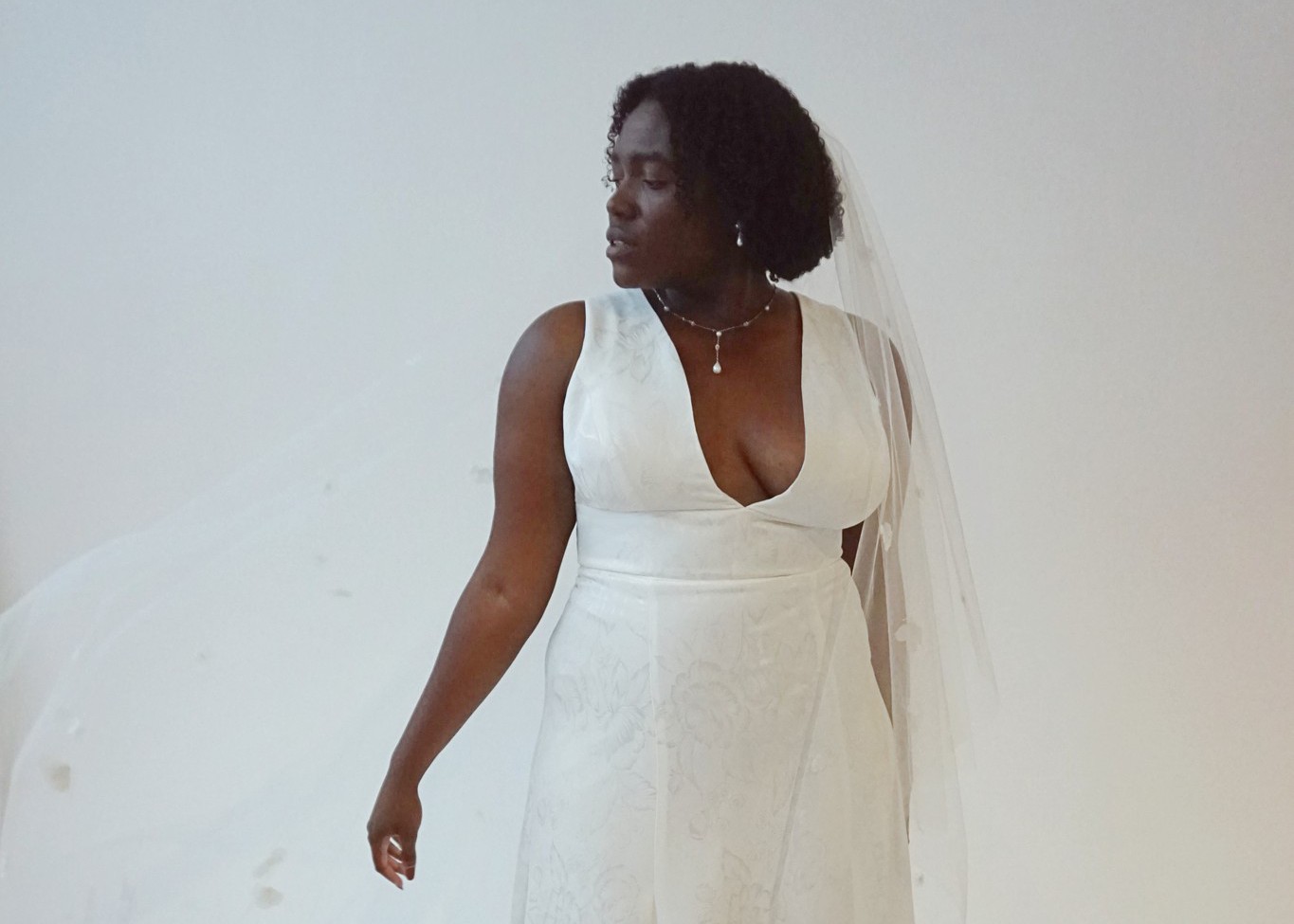 Black bride in a deep v-neck floral wedding dress by Edith Élan