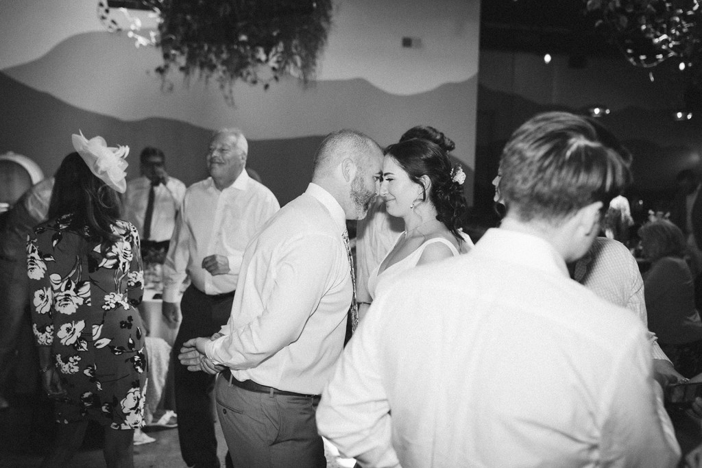 Black and white photo of the newlyweds sharing a moment on the wedding reception dancefloor