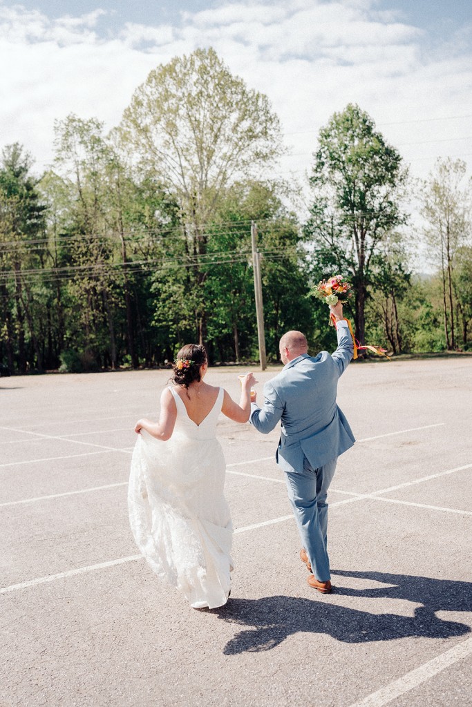 The bride and groom walking on the Highland Brewing property in Asheville NC