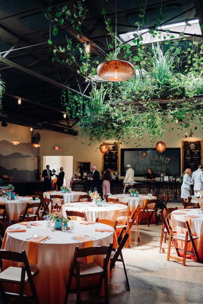 The barrel room at Highland Brewery decorated with greenery for the wedding reception