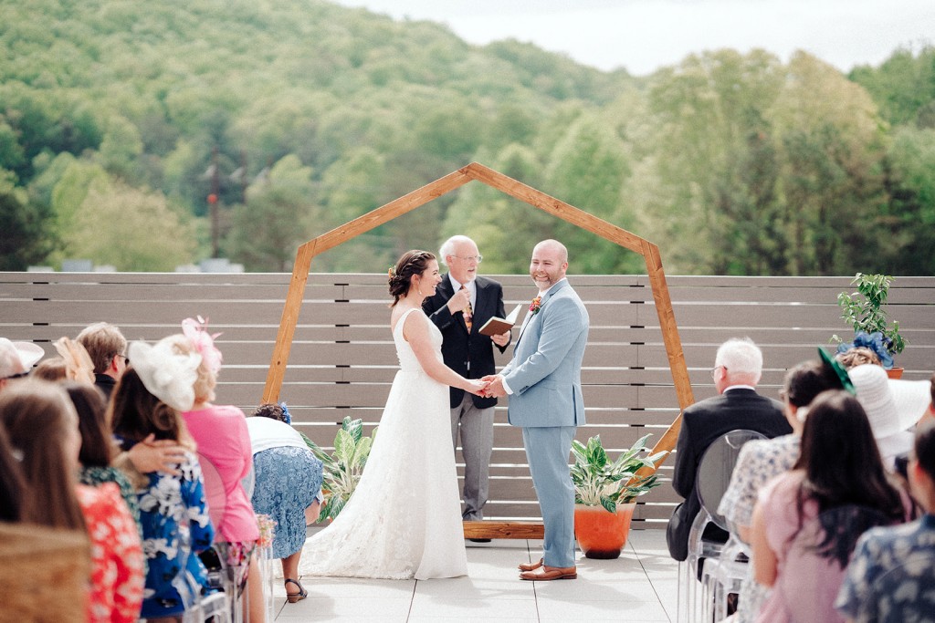 The bride and groom standing together during their Asheville brewery wedding ceremony.