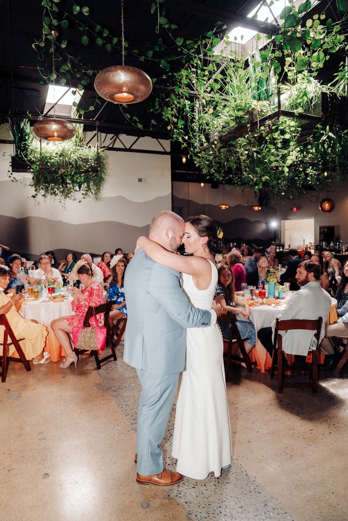 The bride and groom during their first dance at the Highland Brewing barrel room reception