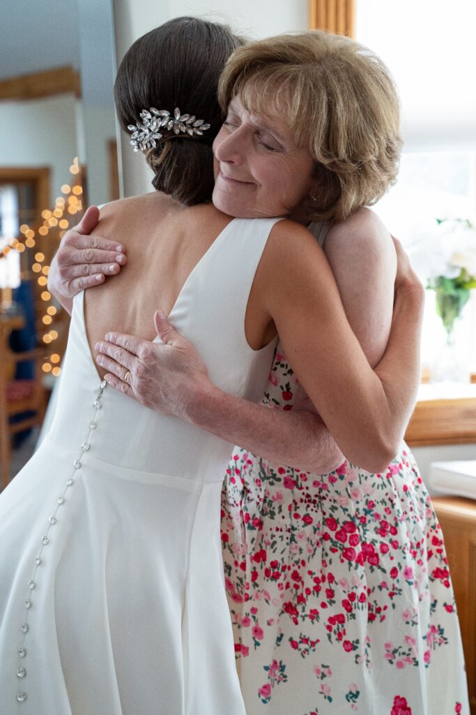The bride and mother of the bride hugging