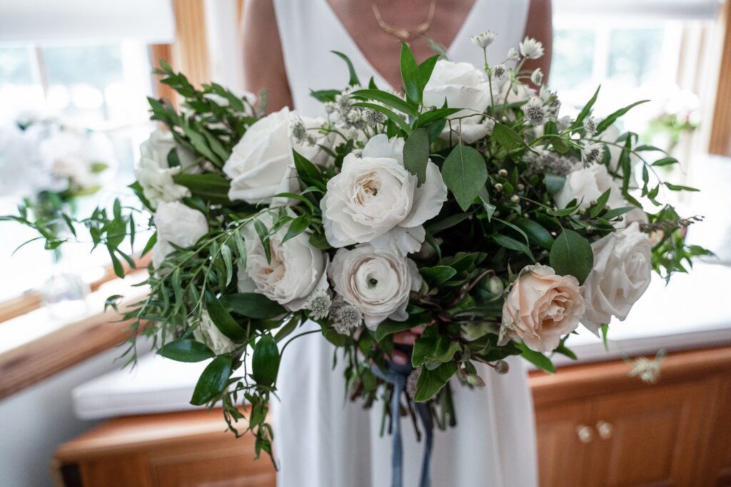 Large bridal bouquet with white roses and peonies and greenery