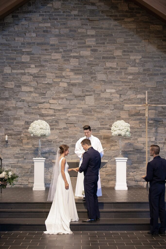 Bride and groom exchanging rings during their Cleveland Ohio wedding ceremony