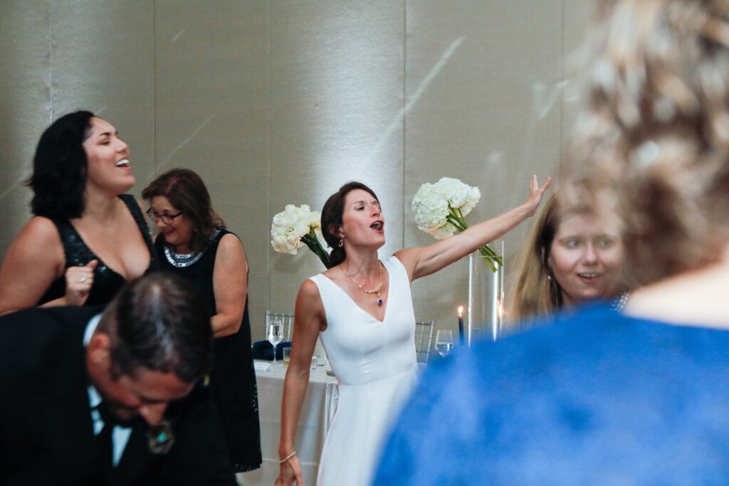 Bride in her bespoke wedding gown enjoying the reception with guests