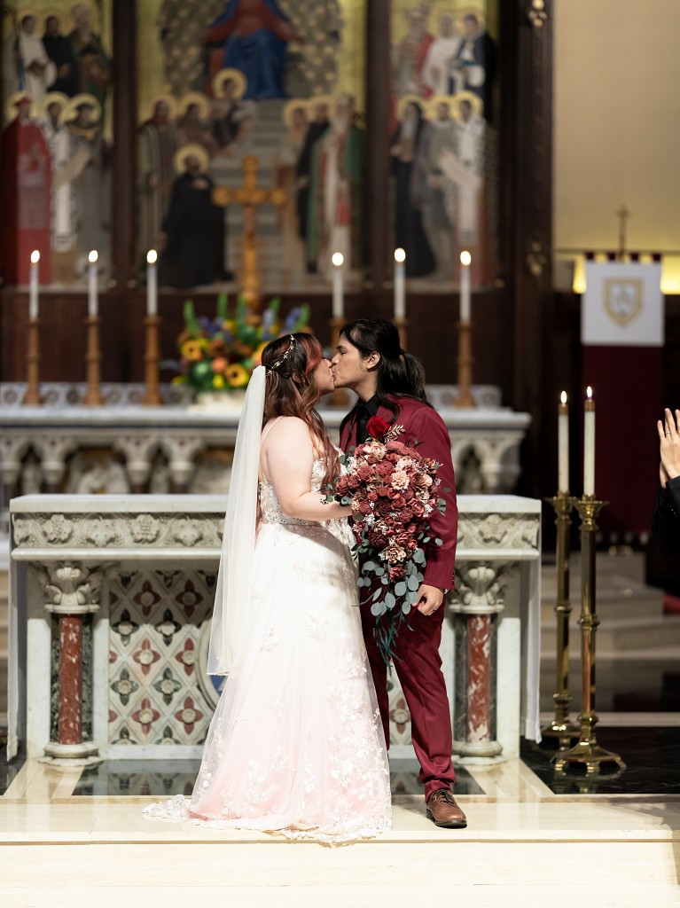 Fordham University Church wedding ceremony first kiss as husband and wife.