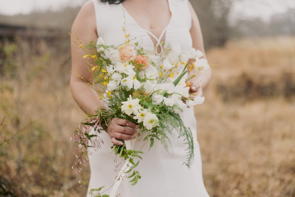 Wilderkind inspired bridal bouquet with pastel wildflowers in an organic shape.